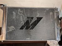 Front view of Mishimoto aluminum radiator showing logo and fin condition