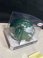 Right side angle of the sealed mini helmet showing the signature, JSA sticker, and Eagles wing logo