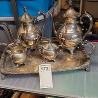 Complete tea and coffee set arranged on ornate rectangular tray, showing all items and general condition.