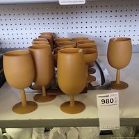 Front view of the lot showing different styles of frosted mustard yellow stemware glasses and the mid-century modern tray behind them.