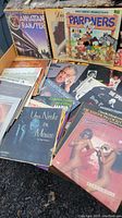 Photo shows several vinyl LP albums including Manhattan Transfer, Walt Disney productions Pardners, Una Noche En Mexico, and Houston Person.