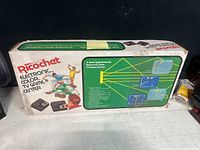 Photo of the vintage Ricochet Electronic Color TV Game Console box showing front and top with colorful artwork and description of the game features.