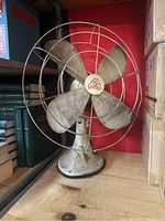 Full view of vintage Hunter metal oscillating fan showing front, base, and blade cage