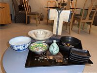 Full lot view showing tray, dishes, bowls, vase, sculpture, and ceramic ornament arranged.