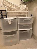 Overview of multiple plastic storage drawer units and stackable containers arranged together.
