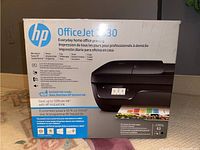 Photo of original product packaging box for HP OfficeJet 3830 printer with model and key features visible