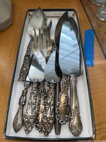 Box of nine utensils showing handles and blades grouped