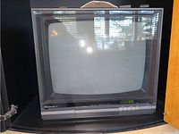 NEC CRT TV monitor with visible control panel and screen reflected with light.