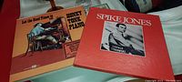 Two vintage LP records displayed, one titled Honky Tonk Piano, other Spike Jones, showing covers and record sleeves.