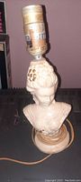 Lamp depicting a Victorian lady bust, 8 inches tall, with original power cord and untested light socket.
