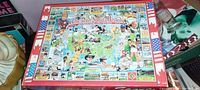 Top of the American Sports History puzzle box showing colorful illustrated sports-themed puzzle image with patriotic border.