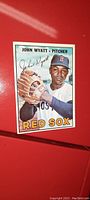 Front of baseball card showing John Wyatt pitcher in Red Sox uniform holding a baseball glove.