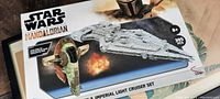 Box front showing Star Wars Mandalorian Boba Fett's Starfighter and Imperial Light Cruiser set with number of pieces and recommended age