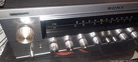 Close-up of the front control panel showing volume and tuning knobs, FM/AM dial, and Sony branding.