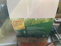 Box front showing Vigoro branding and product information for 100 ft 3/4 in premium soaker hose kit.