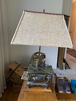 Full view of antique brass stovetop lamp showing overall design and fabric shade.