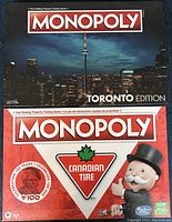 Photo shows two Monopoly board game boxes, Toronto Edition and Canadian Tire Edition, side by side with clear branding and artwork visible.