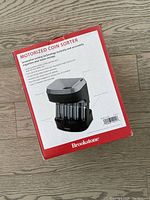 Rear and side view of the Brookstone motorized coin sorter box showing product features and specifications.