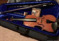 Full size violin in open lined case with bow, rosin and extra strings