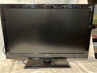 Front view of Seiki 23" monitor showing screen and attached base stand.