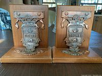 Pair of wooden University of Toronto bookends showing metal crest plaques on front and base.