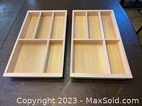 Top view of two wood drawer organizers showing compartment layout and natural finish.