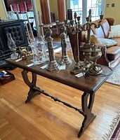 Full view of console table with multiple candle holders shown on top (contents not included).