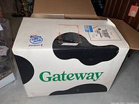 Gateway computer box with large cow print pattern and Gateway logo, indicating vintage product packaging.