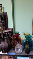 Group shot of all ten glass pitchers and vases showing color range and shapes