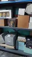 Top shelf showing boxed Minions glassware set and Grecian pattern box