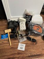 Lot contents showing surge protectors, cleaning brushes, wooden mallet, Sony DVC tape, wire connectors, paraffin wax, and portable fan/heater