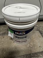Photo of entire pail of Dulux Expert1 ceiling white paint from top angle showing lid and handle