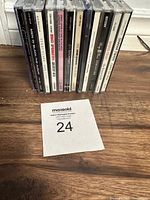 Photo of 12 used music CDs in jewel cases including artists Shania Twain, Boyz II Men, Bruce Springsteen, and others.