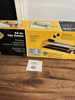 Photo of the box labeling showing brand QEP, 14 inch tile cutter with 350 mm cutting capacity, and usage instruction images.