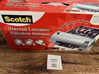 Photo of the Scotch Thermal Laminator box and packaging showing product branding, usage information, and condition.