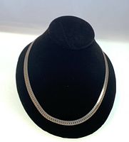 Full view of the vintage sterling silver snakeskin patterned heavyweight chain necklace displayed on a black stand.