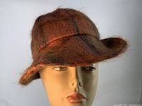 Front angle view showing the shape, brim, and tartan mohair texture of the ladies hat on a mannequin head.