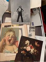 Photo showing several pieces of vintage ephemera including illustrated cards and black and white photo