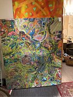 Front view of large abstract artwork showing vibrant swirling patterns and bright colors on canvas.