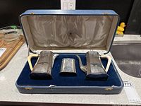 Three-piece set in fitted blue vinyl case with velvet base and satin lid