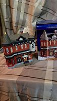 Photo of Dickens Collectibles Towne Christmas Village lighted police station with box to side.
