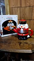 Photo of the Holiday Nutcracker cookie jar closed with original box behind it.