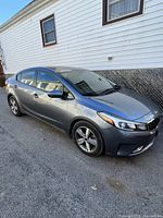 Driver’s side front three-quarter view showing exterior body, alloy wheels