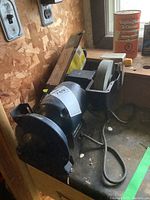 Mastercraft wet and dry grinder on a workbench showing motor and one grinding wheel.