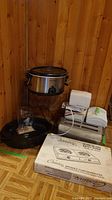 Full lot showing slow cooker, toaster, grinder, roasting pan, wine rack, buffet range box