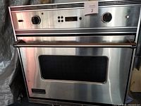 Front view of Viking professional built-in oven showing the glass window door, stainless steel finish, and control knobs.