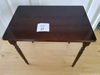 Top view of the rectangular cherry wood table showing the surface condition and turned legs.