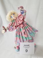Full view of the Daigle paper mache clown doll showing pose, costume, and hair details.