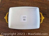 Top view of rectangular yellow-handled pan with white interior and an auction lot number label on the bottom.