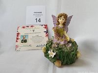 Musical Garland Fairy figurine with certificate and auction card displayed.